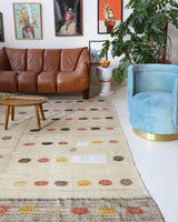 Vintage kilim rug in living room setting, old rug, antique rug, pastel colors, faded colors, Turkish rug, vintage rug, soft rug, Portland, Oregon, rug store, rug shop, local shop, earthy tones, earthy colors, warm colors