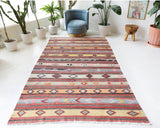 Vintage kilim rug in room decor setting, old rug, antique rug, pastel colors, faded colors, Turkish rug, vintage rug, soft rug, Portland, Oregon, rug store, rug shop, local shop, antique kilim rug, bold colors, bright colors, faded colors