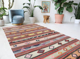 Vintage kilim rug in room decor setting, old rug, antique rug, pastel colors, faded colors, Turkish rug, vintage rug, soft rug, Portland, Oregon, rug store, rug shop, local shop, antique kilim rug, bold colors, bright colors, faded colors