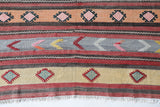 Vintage kilim rug in room decor setting, old rug, antique rug, pastel colors, faded colors, Turkish rug, vintage rug, soft rug, Portland, Oregon, rug store, rug shop, local shop, antique kilim rug, bold colors, bright colors, faded colors