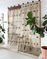 Vintage kilim rug in living room setting, old rug, antique rug, pastel colors, faded colors, Turkish rug, vintage rug, soft rug, Portland, Oregon, rug store, rug shop, local shop, earthy tones, earthy colors, warm colors