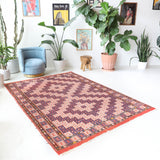 Vintage kilim rug in room decor setting, old rug, antique rug, pastel colors, faded colors, Turkish rug, vintage rug, soft rug, Portland, Oregon, rug store, rug shop, local shop, antique kilim rug, bold colors, bright colors, faded colors