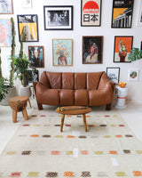 Vintage kilim rug in living room setting, old rug, antique rug, pastel colors, faded colors, Turkish rug, vintage rug, soft rug, Portland, Oregon, rug store, rug shop, local shop, earthy tones, earthy colors, warm colors