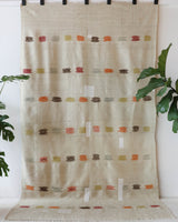 Vintage kilim rug in living room setting, old rug, antique rug, pastel colors, faded colors, Turkish rug, vintage rug, soft rug, Portland, Oregon, rug store, rug shop, local shop, earthy tones, earthy colors, warm colors