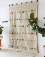 Vintage kilim rug in living room setting, old rug, antique rug, pastel colors, faded colors, Turkish rug, vintage rug, soft rug, Portland, Oregon, rug store, rug shop, local shop, earthy tones, earthy colors, warm colors