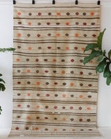 Vintage kilim rug in living room setting, old rug, antique rug, pastel colors, faded colors, Turkish rug, vintage rug, soft rug, Portland, Oregon, rug store, rug shop, local shop, earthy tones, earthy colors, warm colors