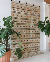 Vintage kilim rug in living room setting, old rug, antique rug, pastel colors, faded colors, Turkish rug, vintage rug, soft rug, Portland, Oregon, rug store, rug shop, local shop, earthy tones, earthy colors, warm colors