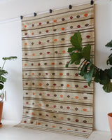 Vintage kilim rug in living room setting, old rug, antique rug, pastel colors, faded colors, Turkish rug, vintage rug, soft rug, Portland, Oregon, rug store, rug shop, local shop, earthy tones, earthy colors, warm colors