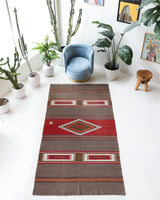 Vintage kilim rug in living room setting, old rug, antique rug, pastel colors, faded colors, Turkish rug, vintage rug, soft rug, Portland, Oregon, rug store, rug shop, local shop, earthy tones, earthy colors, warm colors