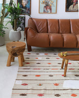 Vintage kilim rug in living room setting, old rug, antique rug, pastel colors, faded colors, Turkish rug, vintage rug, soft rug, Portland, Oregon, rug store, rug shop, local shop, earthy tones, earthy colors, warm colors