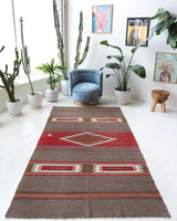 Vintage kilim rug in living room setting, old rug, antique rug, pastel colors, faded colors, Turkish rug, vintage rug, soft rug, Portland, Oregon, rug store, rug shop, local shop, earthy tones, earthy colors, warm colors