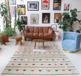 Vintage kilim rug in living room setting, old rug, antique rug, pastel colors, faded colors, Turkish rug, vintage rug, soft rug, Portland, Oregon, rug store, rug shop, local shop, earthy tones, earthy colors, warm colors