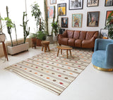 Vintage kilim rug in living room setting, old rug, antique rug, pastel colors, faded colors, Turkish rug, vintage rug, soft rug, Portland, Oregon, rug store, rug shop, local shop, earthy tones, earthy colors, warm colors