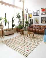 Vintage kilim rug in living room setting, old rug, antique rug, pastel colors, faded colors, Turkish rug, vintage rug, soft rug, Portland, Oregon, rug store, rug shop, local shop, earthy tones, earthy colors, warm colors