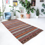 Vintage kilim rug in living room setting, old rug, antique rug, pastel colors, faded colors, Turkish rug, vintage rug, soft rug, Portland, Oregon, rug store, rug shop, local shop, earthy tones, earthy colors, warm colors