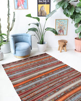 Vintage kilim rug in living room setting, old rug, antique rug, pastel colors, faded colors, Turkish rug, vintage rug, soft rug, Portland, Oregon, rug store, rug shop, local shop, earthy tones, earthy colors, warm colors