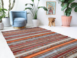 Vintage kilim rug in living room setting, old rug, antique rug, pastel colors, faded colors, Turkish rug, vintage rug, soft rug, Portland, Oregon, rug store, rug shop, local shop, earthy tones, earthy colors, warm colors