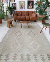 Vintage kilim rug in living room setting, old rug, antique rug, pastel colors, faded colors, Turkish rug, vintage rug, soft rug, Portland, Oregon, rug store, rug shop, local shop, earthy tones, earthy colors, warm colors
