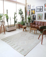 Vintage kilim rug in living room setting, old rug, antique rug, pastel colors, faded colors, Turkish rug, vintage rug, soft rug, Portland, Oregon, rug store, rug shop, local shop, earthy tones, earthy colors, warm colors