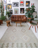 Vintage kilim rug in living room setting, old rug, antique rug, pastel colors, faded colors, Turkish rug, vintage rug, soft rug, Portland, Oregon, rug store, rug shop, local shop, earthy tones, earthy colors, warm colors