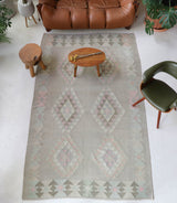 Vintage kilim rug in living room setting, old rug, antique rug, pastel colors, faded colors, Turkish rug, vintage rug, soft rug, Portland, Oregon, rug store, rug shop, local shop, earthy tones, earthy colors, warm colors