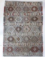 Vintage kilim rug in living room setting, old rug, antique rug, pastel colors, faded colors, Turkish rug, vintage rug, soft rug, Portland, Oregon, rug store, rug shop, local shop, earthy tones, earthy colors, warm colors