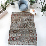 Vintage kilim rug in living room setting, old rug, antique rug, pastel colors, faded colors, Turkish rug, vintage rug, soft rug, Portland, Oregon, rug store, rug shop, local shop, earthy tones, earthy colors, warm colors