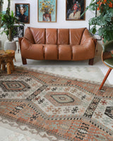 Vintage kilim rug in living room setting, old rug, antique rug, pastel colors, faded colors, Turkish rug, vintage rug, soft rug, Portland, Oregon, rug store, rug shop, local shop, earthy tones, earthy colors, warm colors