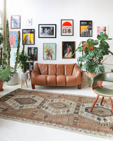 Vintage kilim rug in living room setting, old rug, antique rug, pastel colors, faded colors, Turkish rug, vintage rug, soft rug, Portland, Oregon, rug store, rug shop, local shop, earthy tones, earthy colors, warm colors