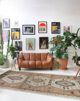 Vintage kilim rug in living room setting, old rug, antique rug, pastel colors, faded colors, Turkish rug, vintage rug, soft rug, Portland, Oregon, rug store, rug shop, local shop, earthy tones, earthy colors, warm colors