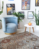 Vintage kilim rug in living room setting, old rug, antique rug, pastel colors, faded colors, Turkish rug, vintage rug, soft rug, Portland, Oregon, rug store, rug shop, local shop, earthy tones, earthy colors, warm colors