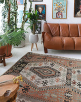 Vintage kilim rug in living room setting, old rug, antique rug, pastel colors, faded colors, Turkish rug, vintage rug, soft rug, Portland, Oregon, rug store, rug shop, local shop, earthy tones, earthy colors, warm colors