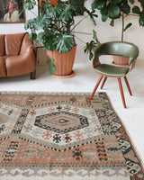 Vintage kilim rug in living room setting, old rug, antique rug, pastel colors, faded colors, Turkish rug, vintage rug, soft rug, Portland, Oregon, rug store, rug shop, local shop, earthy tones, earthy colors, warm colors
