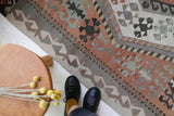 Vintage kilim rug in living room setting, old rug, antique rug, pastel colors, faded colors, Turkish rug, vintage rug, soft rug, Portland, Oregon, rug store, rug shop, local shop, earthy tones, earthy colors, warm colors