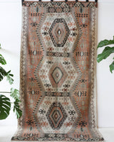 Vintage kilim rug in living room setting, old rug, antique rug, pastel colors, faded colors, Turkish rug, vintage rug, soft rug, Portland, Oregon, rug store, rug shop, local shop, earthy tones, earthy colors, warm colors