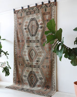 Vintage kilim rug in living room setting, old rug, antique rug, pastel colors, faded colors, Turkish rug, vintage rug, soft rug, Portland, Oregon, rug store, rug shop, local shop, earthy tones, earthy colors, warm colors