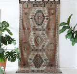 Vintage kilim rug in living room setting, old rug, antique rug, pastel colors, faded colors, Turkish rug, vintage rug, soft rug, Portland, Oregon, rug store, rug shop, local shop, earthy tones, earthy colors, warm colors