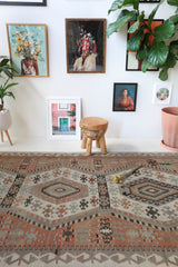 Vintage kilim rug in living room setting, old rug, antique rug, pastel colors, faded colors, Turkish rug, vintage rug, soft rug, Portland, Oregon, rug store, rug shop, local shop, earthy tones, earthy colors, warm colors