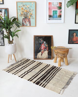 Vintage kilim rug in room decor setting, old rug, antique rug, pastel colors, faded colors, Turkish rug, vintage rug, soft rug, Portland, Oregon, rug store, rug shop, local shop, antique rug