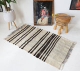 Vintage kilim rug in room decor setting, old rug, antique rug, pastel colors, faded colors, Turkish rug, vintage rug, soft rug, Portland, Oregon, rug store, rug shop, local shop, antique rug