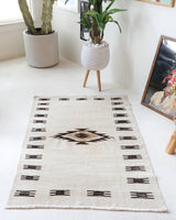 Vintage kilim rug in room decor setting, old rug, antique rug, pastel colors, faded colors, Turkish rug, vintage rug, soft rug, Portland, Oregon, rug store, rug shop, local shop, antique rug