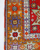 Vintage Turkish rug in a living room setting, pile rug, Turkish rug, vintage rug, portland, rug shop, bright colors, wild shaman, soft rug, bold color, Portland, Oregon, rug store, rug shop, local shop, antique rug