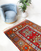 Vintage Turkish rug in a living room setting, pile rug, Turkish rug, vintage rug, portland, rug shop, bright colors, wild shaman, soft rug, bold color, Portland, Oregon, rug store, rug shop, local shop, antique rug