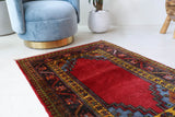 Vintage Turkish rug in a living room setting, pile rug, Turkish rug, vintage rug, portland, rug shop, bright colors, wild shaman, soft rug, bold color, Portland, Oregon, rug store, rug shop, local shop, antique rug