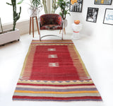 Vintage kilim rug in living room setting, old rug, antique rug, pastel colors, faded colors, Turkish rug, vintage rug, soft rug, Portland, Oregon, rug store, rug shop, local shop, earthy tones, earthy colors, warm colors