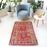 Vintage kilim rug in living room setting, old rug, antique rug, pastel colors, faded colors, Turkish rug, vintage rug, soft rug, Portland, Oregon, rug store, rug shop, local shop, earthy tones, earthy colors, warm colors
