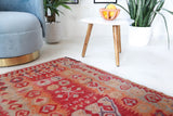Vintage kilim rug in living room setting, old rug, antique rug, pastel colors, faded colors, Turkish rug, vintage rug, soft rug, Portland, Oregon, rug store, rug shop, local shop, earthy tones, earthy colors, warm colors