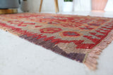 Vintage kilim rug in living room setting, old rug, antique rug, pastel colors, faded colors, Turkish rug, vintage rug, soft rug, Portland, Oregon, rug store, rug shop, local shop, earthy tones, earthy colors, warm colors