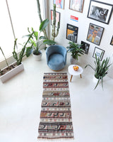 Vintage Turkish runner rug in living room setting, old rug, antique rug, pastel colors, faded colors, Turkish rug, vintage rug, soft rug, Portland, Oregon, rug store, rug shop, local shop