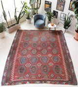 Vintage kilim rug in living room setting, old rug, antique rug, pastel colors, faded colors, Turkish rug, vintage rug, soft rug, Portland, Oregon, rug store, rug shop, local shop, earthy tones, earthy colors, warm colors